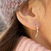 Burren jewellery 18k gold plate labelled with love earrings on ear